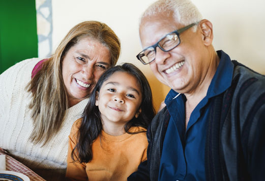 Grandparents smiling with grandchild