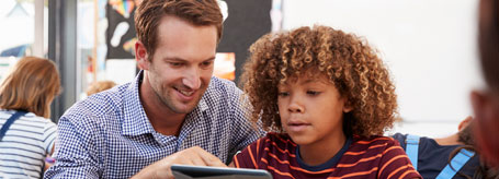 Man and teen looking at tablet