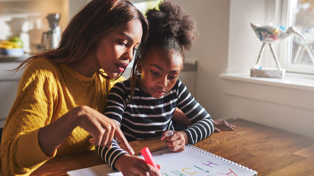 Woman and young girl colouring