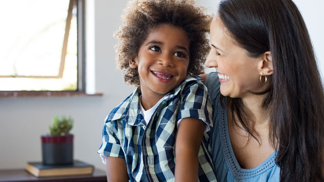 Woman smiling and looking at child