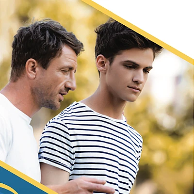 a father and son talking while walking