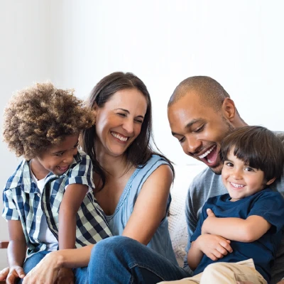 A mother and father relaxing with their 2 children