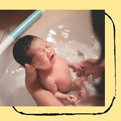 a mother bathing an infant